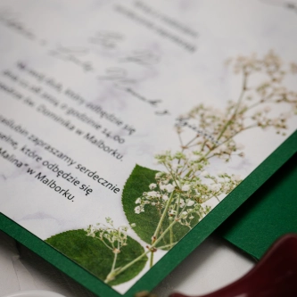 Zielone zaproszenie z&nbsp;motywem marmuru i&nbsp;gipsówki z&nbsp;piękną wstążką szyfonową i&nbsp;kopertą ciemno zieloną